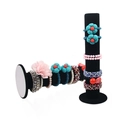 Vertical black velvet stand for displaying hair scrunchies and bracelets on white background - Black