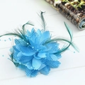 Blue mesh flower hair accessory with delicate feathers and beads on white wood - Lake Blue