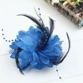 Detailed close-up of a blue mesh flower hair clip with black feathers and beads - Sapphire Blue