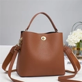 Detail of dark brown lychee texture leather bucket bag with golden twist lock and wide strap - Khaki/Earth Yellow