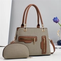 Close-up of woven beige fabric and brown leather trim on a stylish lady handbag set - Green