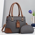 Elegante borsa a mano in tessuto grigio con manici in pelle marrone e tracolla regolabile - Grigio