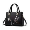 Classic black litchi grain shoulder bag with elegant floral embroidery and top handles - Black