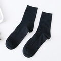 Men's solid black vertical ribbed business crew socks in a minimalist flat lay - One Size / Black