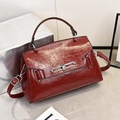 Elegant burgundy leather crossbody bag with silver metal lock and adjustable strap - Red