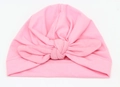 Detail of pink cotton knit baby turban hat with decorative knot on white background - Pink