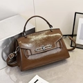 Detailed macro of brown oil-wax leather texture and silver buckle on a stylish handbag - Brown