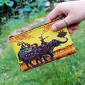 Handheld yellow canvas coin purse featuring ethnic Thai elephant and character prints - Pattern 16
