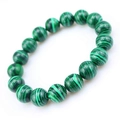 Macro view of green malachite beaded bracelet showing natural stone textures and patterns - 6mm
