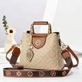 Beige crossbody bag with brown leather accents and logo print shown with a woven strap - Apricot