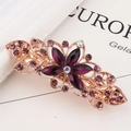 Fermaglio dorato per capelli con foglie e strass viola su fondo in marmo - Petali Viola