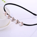 Black headband with golden leaf-shaped metal accessory featuring faux pearls and rhinestones - Pearl Leaf