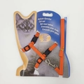 Detail of adjustable orange nylon cat harness and leash set on display packaging - Orange