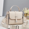 Close-up of beige lychee textured handbag with wide fabric strap and silver hardware - Off-white