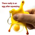 Funny chicken squeeze toy keychain showing egg laying action for stress relief - Default