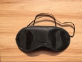 Breathable black silk sleep mask with elastic straps on light wood background - Bulk With Nose Pad Style