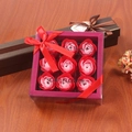 Detailed view of 9 gradient pink soap rose flowers in a gift box with a red ribbon - Red Mix
