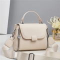 Close-up of beige lychee grain leather handbag with wide fabric strap and zipper details - Off-white