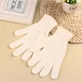 Close-up of white knitted warm gloves featuring elastic ribbed cuffs for adults - One Size / White