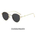 Ovale goldene Metallsonnenbrille mit dunkelgrauen Gläsern und modischen Wellenbügeln - Goldrahmen Schwarzgrau