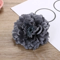Close-up of a dark grey artificial peony flower hair clip with layered fabric petals - Silver Gray