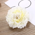 Detailed close-up of a cream-colored silk peony flower clip on a wooden background - Off-white