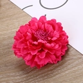 Macro shot of rose red fabric carnation flower head with detailed petals and wood background - Rose Red