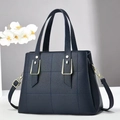 Detail of dark blue lychee grain handbag with square quilting and gold hardware - Blue