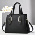 Elegant black lychee textured quilted handbag with gold hardware and shoulder strap - Black