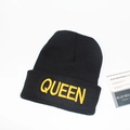 Close-up of a black knit beanie featuring bold yellow Queen embroidery on the cuff - M / Black / QUEEN Embroidery / Gold