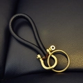 Vintage brass keychain with black leather loop and heavy metal D-ring buckle on leather - Black