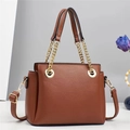 Elegant caramel brown cross-body bag with golden chain handle and lychee texture - Caramel color