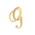 Detailed view of a gold-plated letter Q brooch with sparkling rhinestones on white background - Letter G / Gold