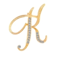 Macro shot of cursive letter K brooch in gold finish with sparkling crystal rhinestones - Letter K / Gold