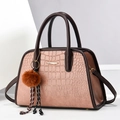 Pink crocodile pattern handbag with dark brown handles and a fluffy pom-pom charm - Medium / Pink