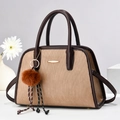 Elegant light brown striped handbag with gold hardware and luxury plush charm - Khaki