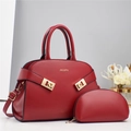 Elegant red leather handbag set with two pieces, featuring a top-handle bag and gold hardware - Red