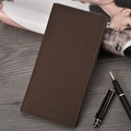 Brown leather long wallet for men placed on a wooden desk next to a magazine - 055 Series / Dark Brown