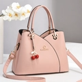 Elegant pink lychee leather handbag with cherry charm and adjustable shoulder strap - Pink