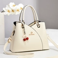 Elegant off-white crossbody bag in pebble leather with a cherry pendant and long strap - Off-white