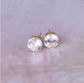 Detailed macro view of 8mm round zircon stud earrings with elegant gold six-prong setting - Gold + White
