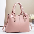 Detail of light pink tote bag featuring lychee texture leather and polka dot silk scarf - Pink