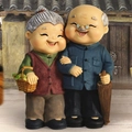 Set di statuette nonni con nonno in abito blu e nonna con cestino in resina - 935-2 Fare la spesa