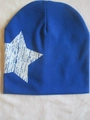 Blue knitted infant beanie with white star print on soft pink plush background - White Star / Sapphire Blue