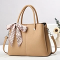 Detail of khaki faux leather tote bag with lychee texture and heart pattern silk scarf - Khaki