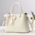 Detail shot of beige lychee leather handbag with a pink plaid decorative silk scarf - Off-white