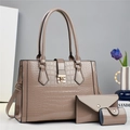 Detailed close-up of beige crocodile pattern faux leather handbag set with gold clasp - Khaki