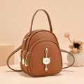 Brown litchi leather mini backpack with golden cat charm and rhinestone detail - Khaki/Earth Yellow