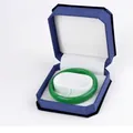 Emerald green round jade bangle presented in a premium blue hexagonal velvet gift box - Bracelet Box / Blue With White Interior