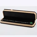 Octagonal velvet jewelry box with silver necklace and green gemstone pendant display - Necklace Box / Yellow With Black Interior